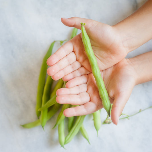 child holding peas