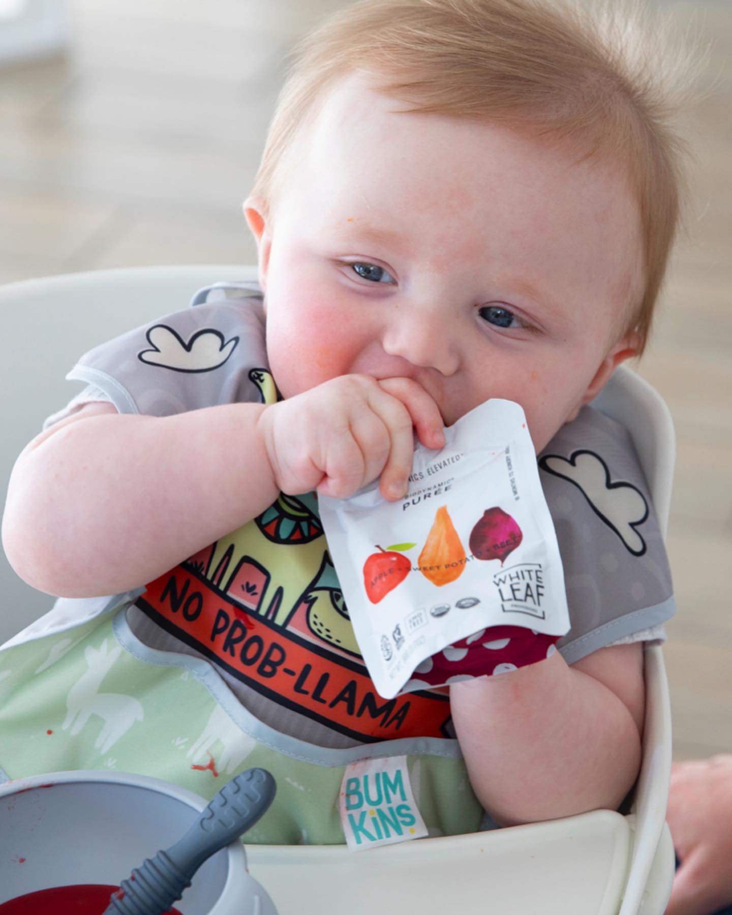 baby enjoying organic food puree pouch