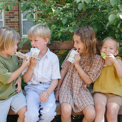 children laughing while eating baby & toddler organic fruit pouches by white leaf organics