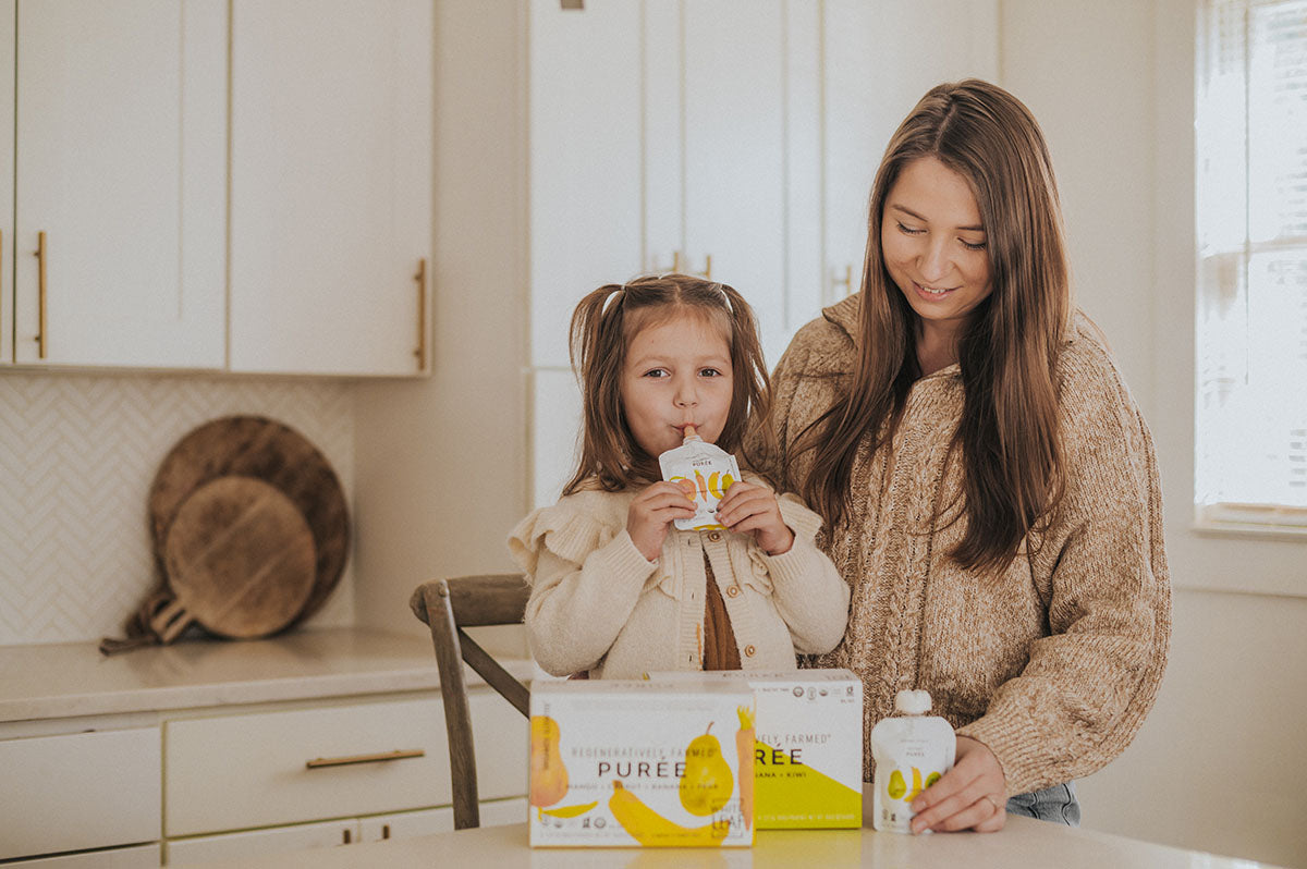 mom and toddler enjoying baby food puree pouches